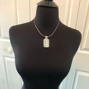 Silver colored oblong pendant 2 in by 1 in - light gold trim